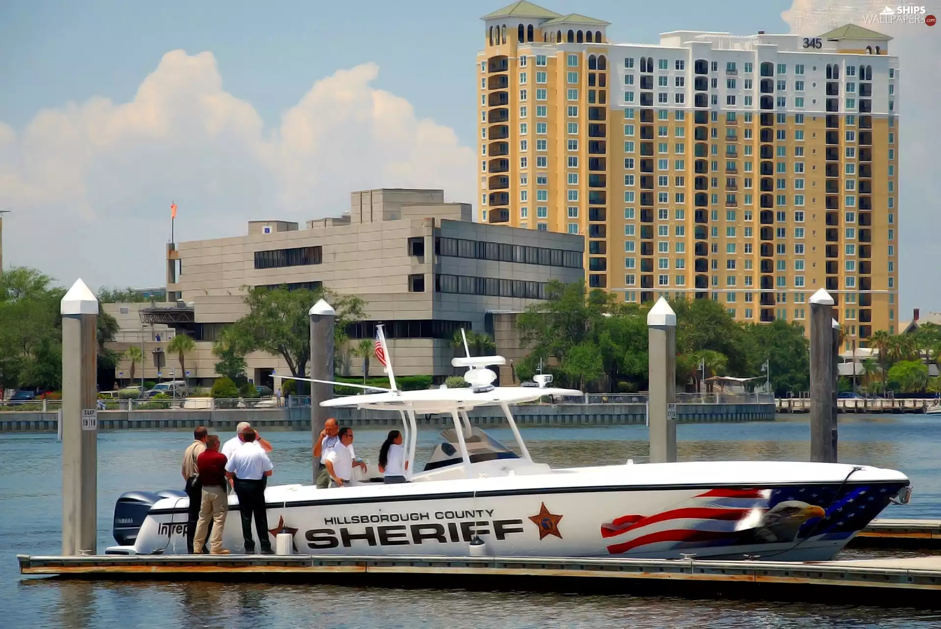 Motor boat, People, buildings, River